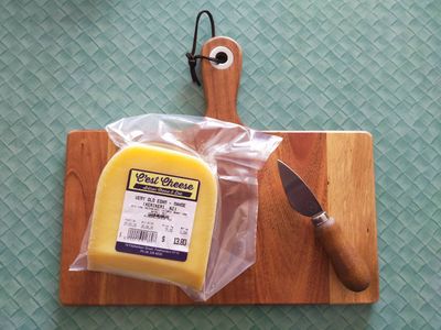 A photo of wrapped very old edam on a cheese board