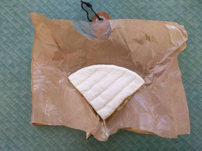 A photo of double cream brie on a chopping board
