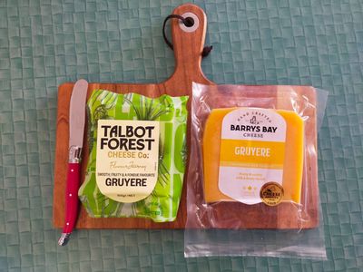 Photo of two gruyère cheeses on a cheese board, one from Talbot Forest Cheese Co. and one from Barrys Bay Cheese
