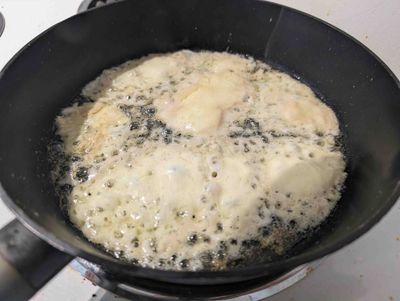 Photo of cut scamorza inserted into a frying pan with too much oil