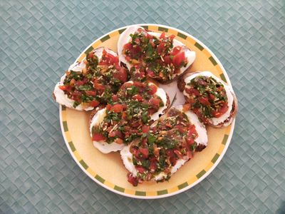 Photo of the finished bruschetta recipe, with toppings of cherry tomatoes and spinach
