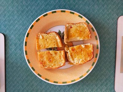 A photo of two slices of scone buttered on a plate
