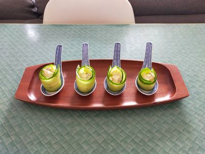 A photo of four spoons of greek roulade