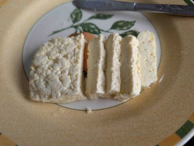 Photo of raw halloumi, sliced, ready to be fried