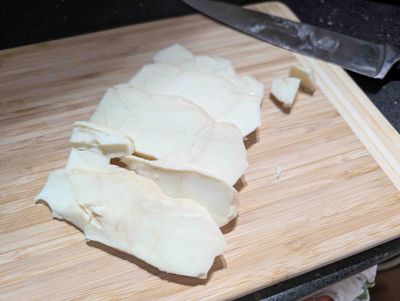 Photo of raw, cut scamorza on a chopping board